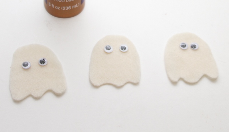 Glue eyes on your ghost for the Halloween mini bag craft for kids