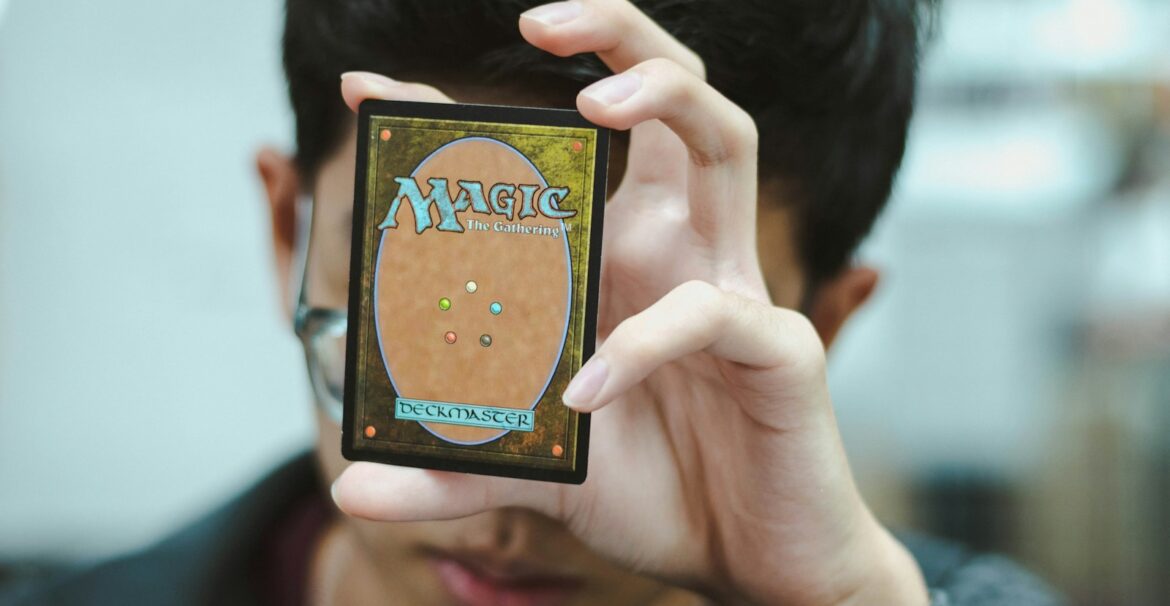 boy holding Magic: The Gathering trading card