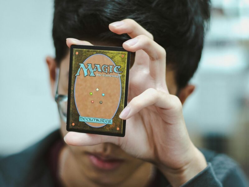 boy holding Magic: The Gathering trading card